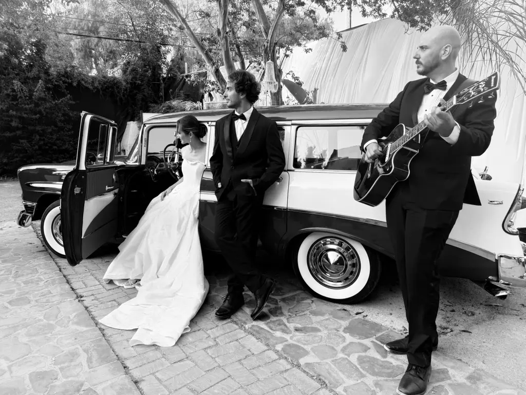 J. Daniel with a newly married couple at their wedding
