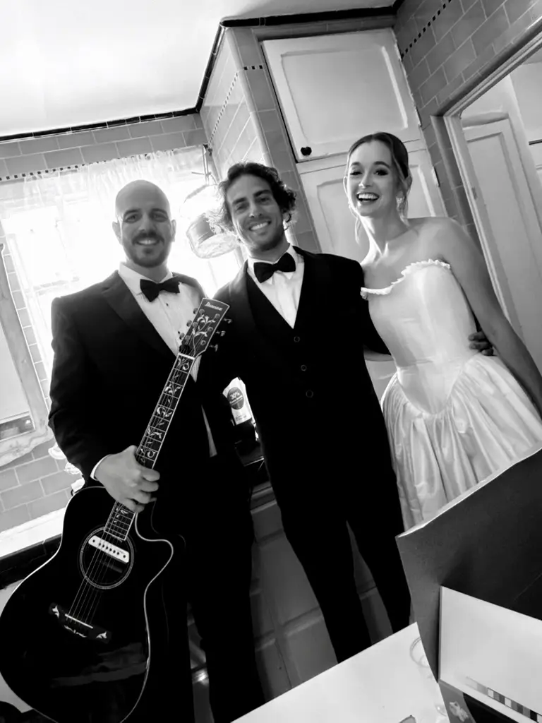 J. Daniel with a bride and groom on their wedding day